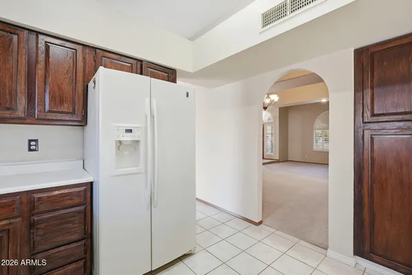 a kitchen with a refrigerator sink and cabinets