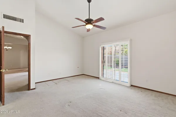 a view of empty room with ceiling fan