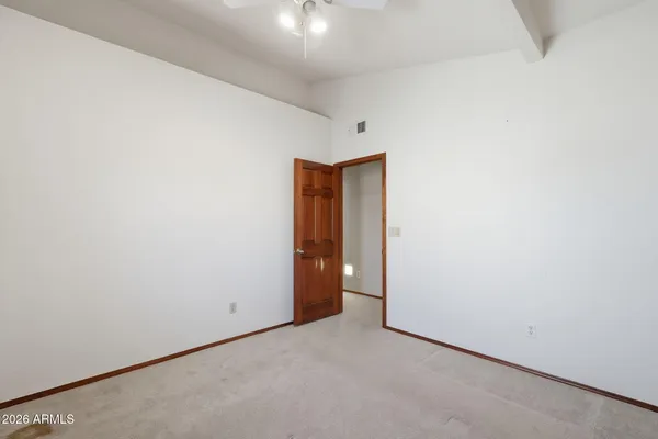 an empty room with a chandelier fan