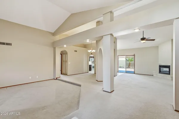 an empty room with windows and entrance