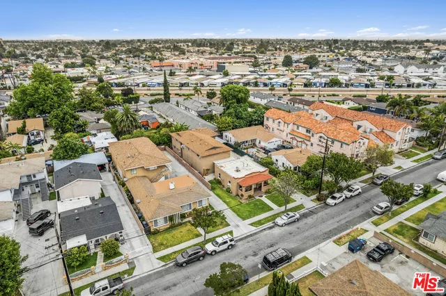 an aerial view of residential houses with outdoor space and street view