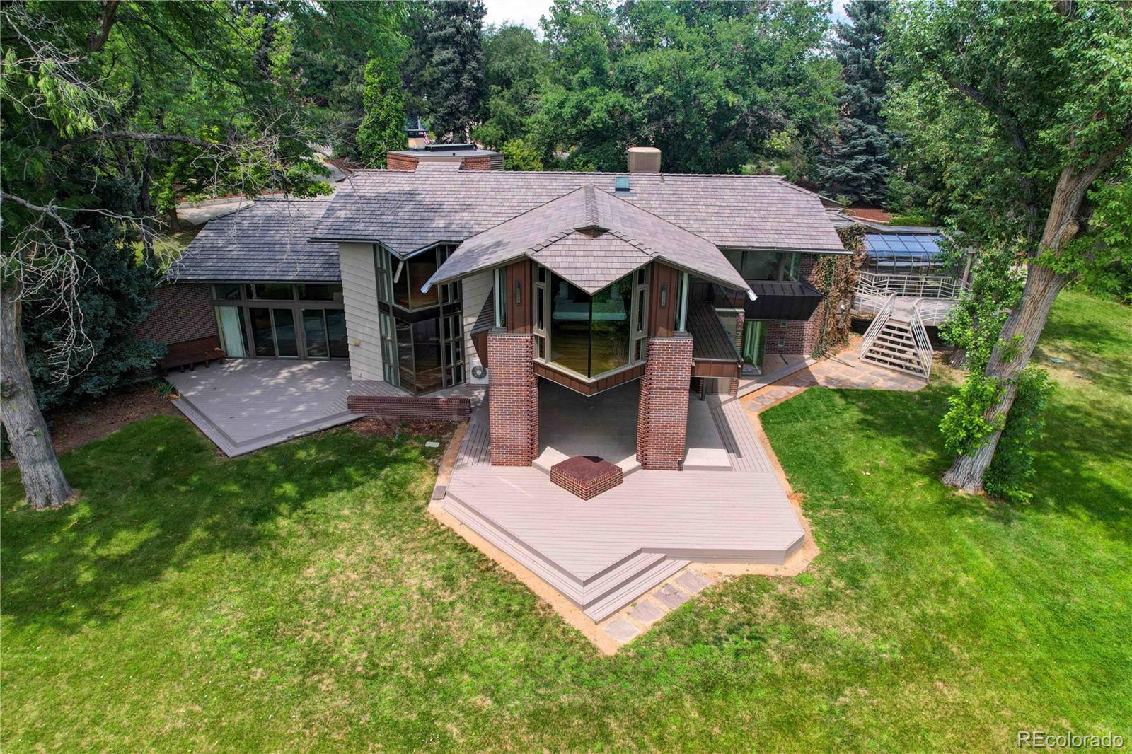 a view of a house with a yard deck and a garden