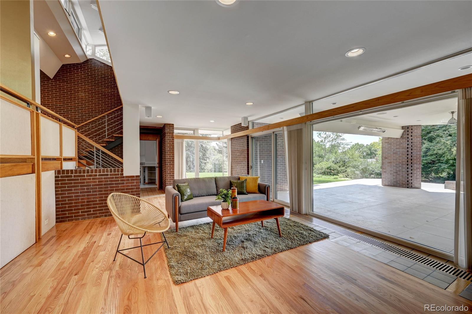 5140 Juniper Street Bow Mar, CO 80123 - Photo 13 of 40 a living room with furniture and a wooden floor