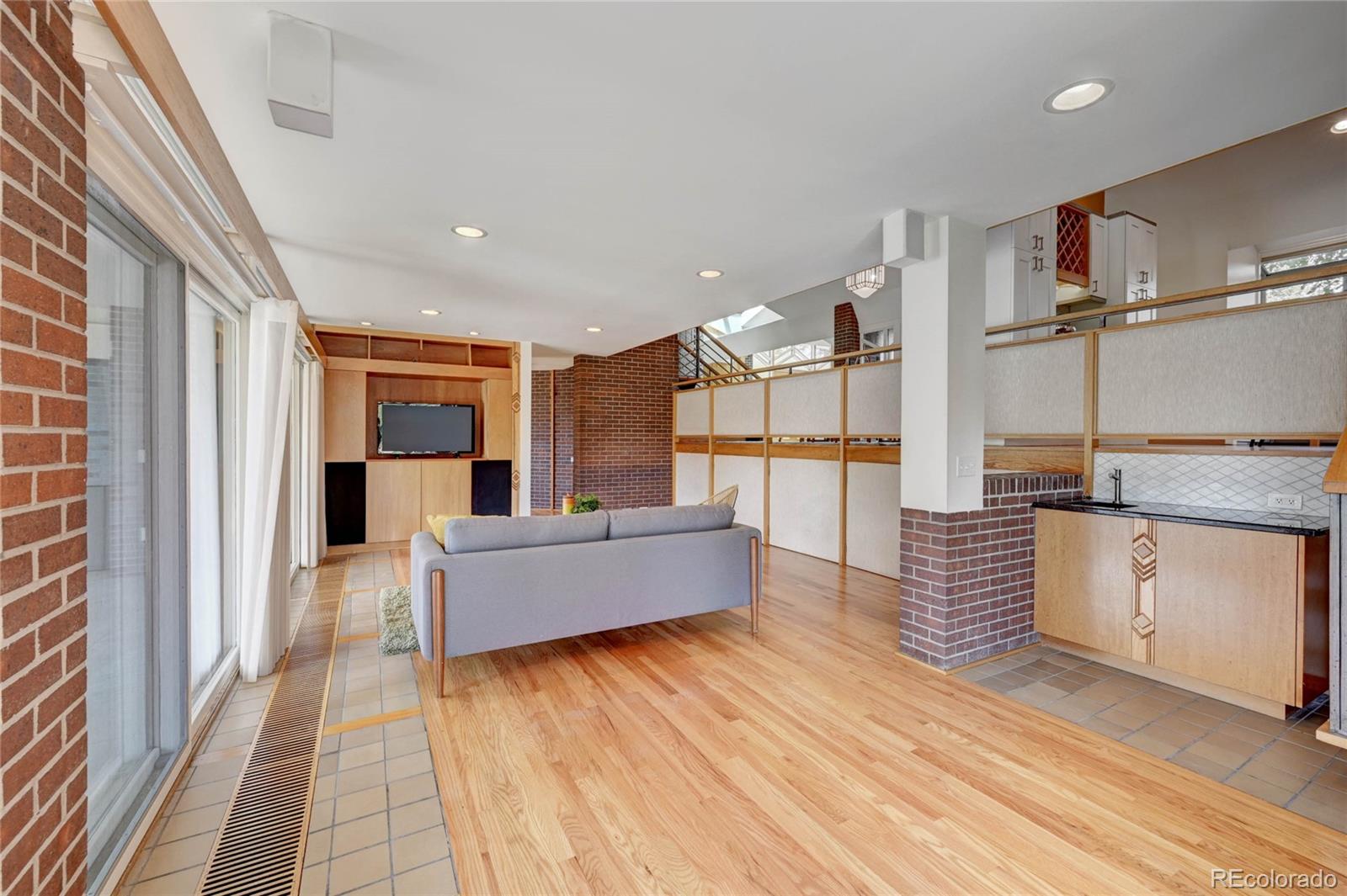 5140 Juniper Street Bow Mar, CO 80123 - Photo 14 of 40 a large kitchen with kitchen island a large counter top space and stainless steel appliances