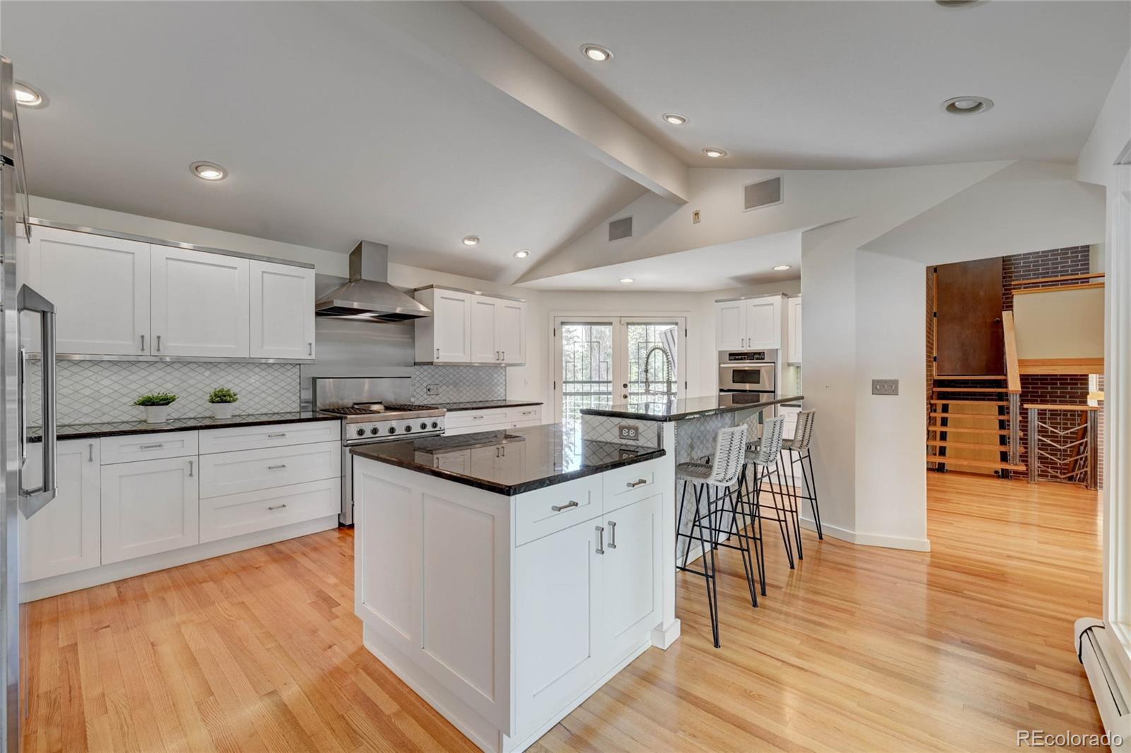 5140 Juniper Street Bow Mar, CO 80123 - Photo 18 of 40 a kitchen with white cabinets and appliances