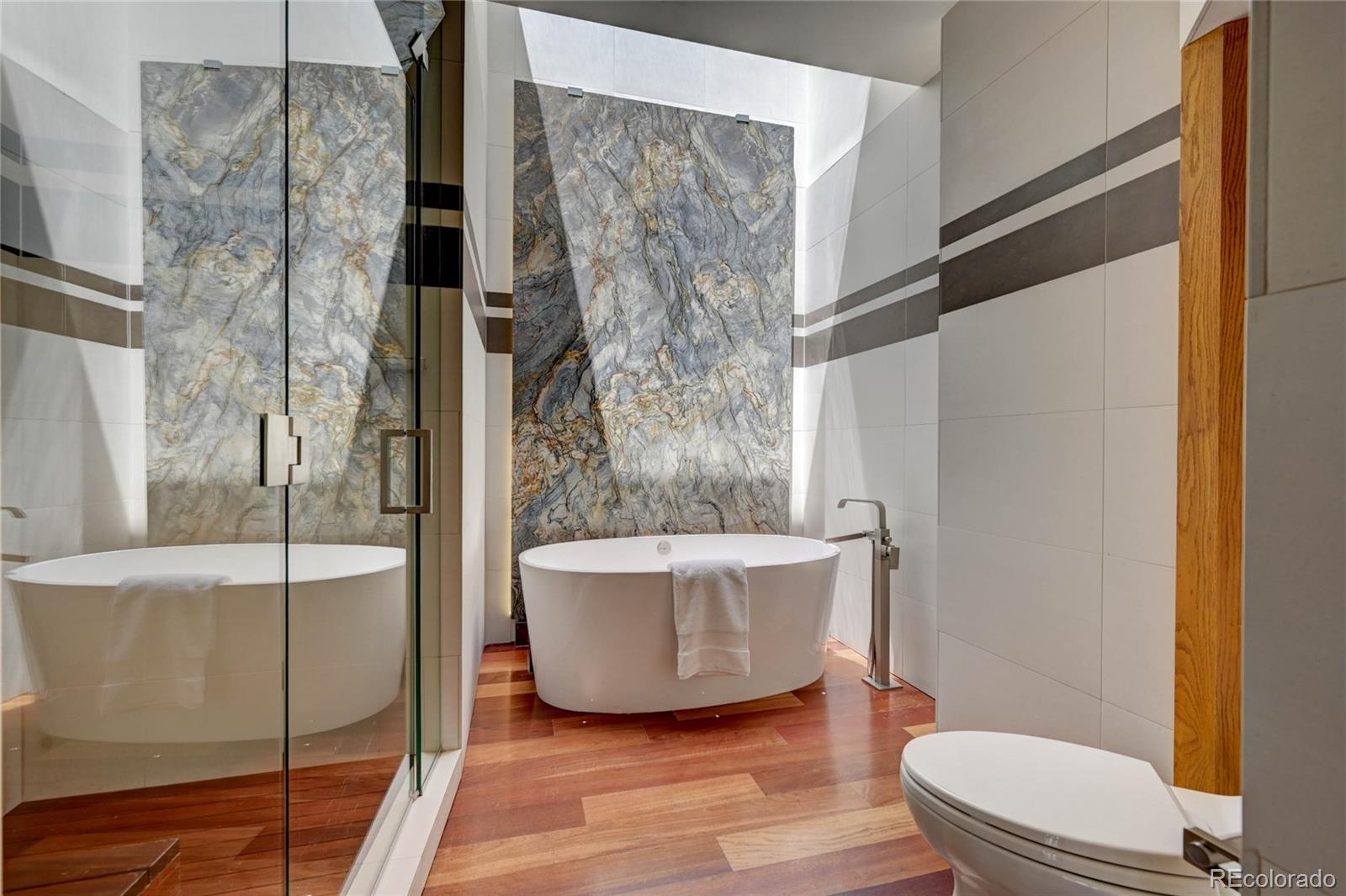 5140 Juniper Street Bow Mar, CO 80123 - Photo 26 of 40 a bathroom with a bathtub and shower