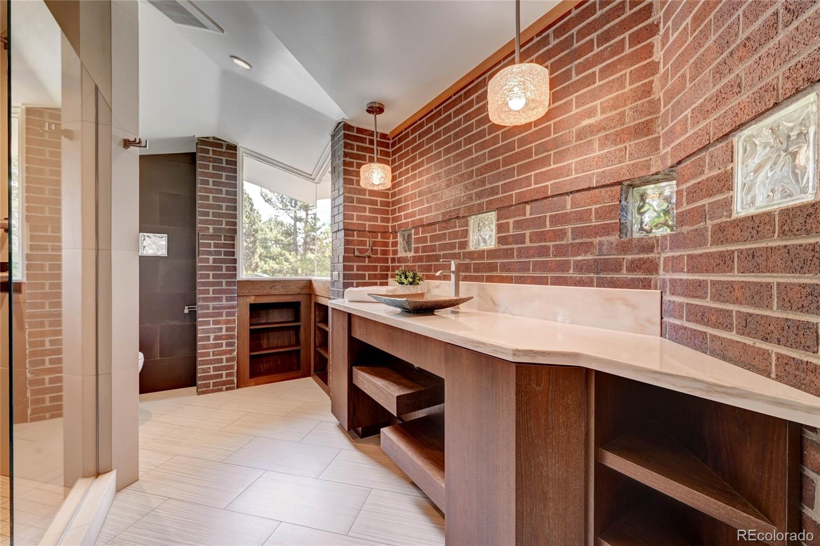 5140 Juniper Street Bow Mar, CO 80123 - Photo 28 of 40 a kitchen with kitchen island a sink stainless steel appliances and cabinets