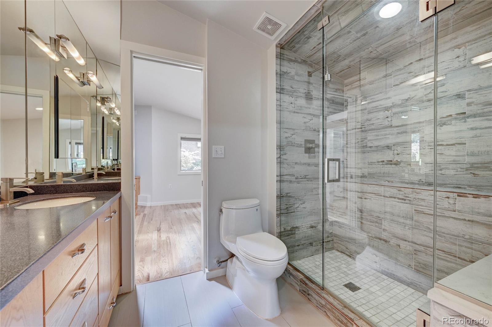 5140 Juniper Street Bow Mar, CO 80123 - Photo 33 of 40 a bathroom with a granite countertop sink toilet and shower