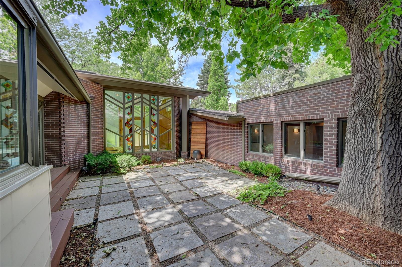 5140 Juniper Street Bow Mar, CO 80123 - Photo 8 of 40 a front view of a house with garden