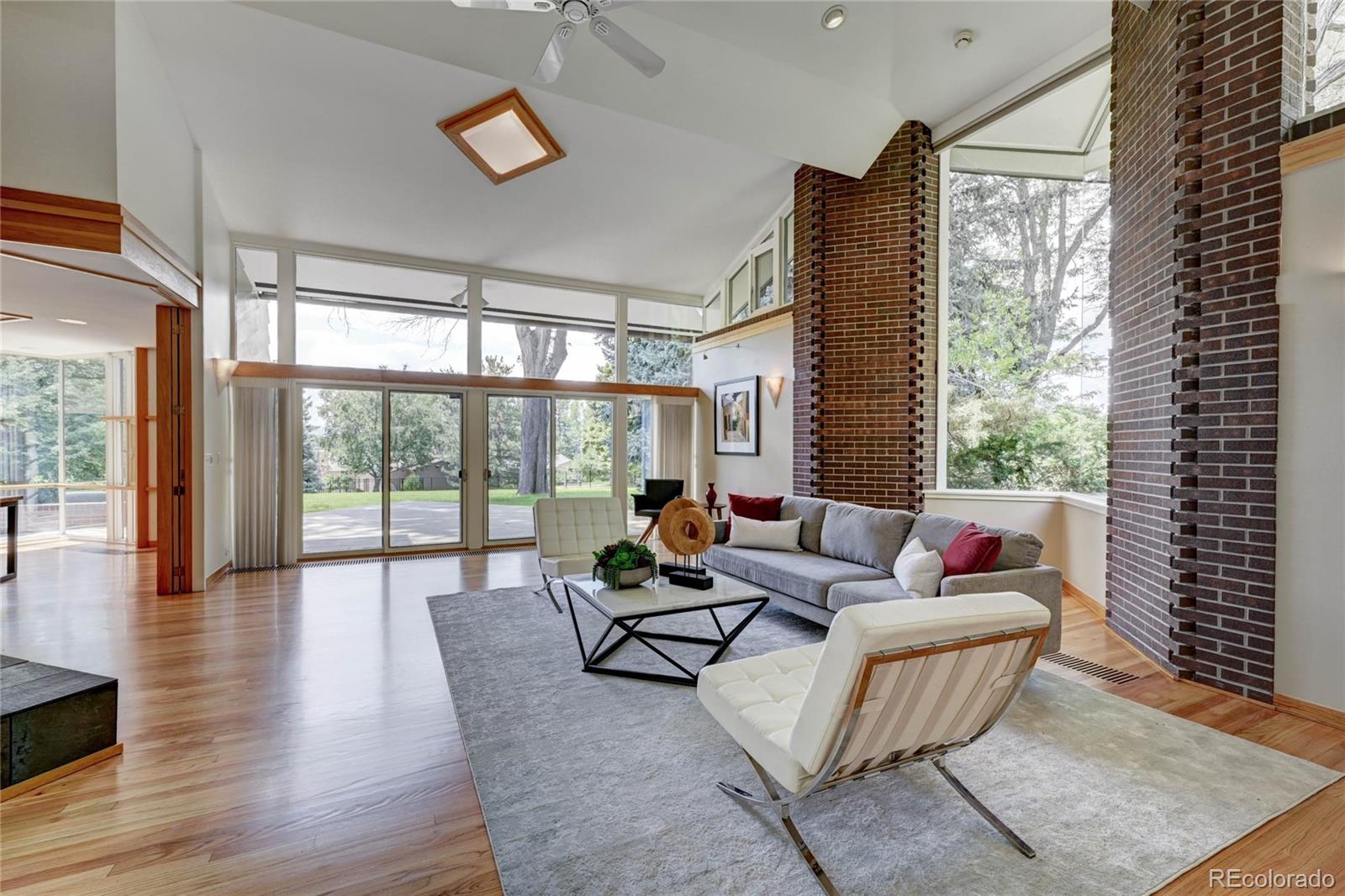 5140 Juniper Street Bow Mar, CO 80123 - Photo 9 of 40 a living room with furniture and floor to ceiling windows