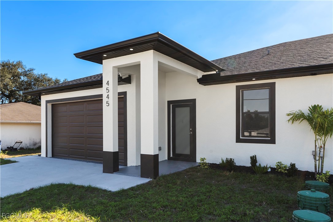 4649-4651 24th Street Southwest Lehigh Acres, FL 33973 - Photo 4 of 29 a front view of a house with a yard