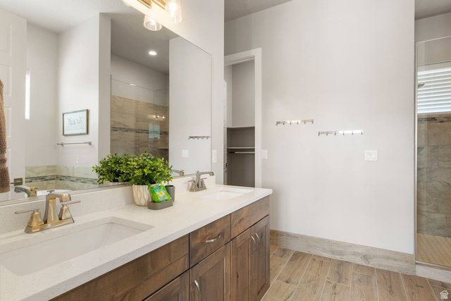 2600 Ocotillo Way, Unit 56 Santa Clara, UT 84765 - Photo 13 of 33 Bathroom with double vanity, light wood finished floors, and a shower stall