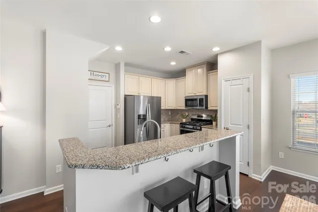a kitchen with refrigerator and microwave