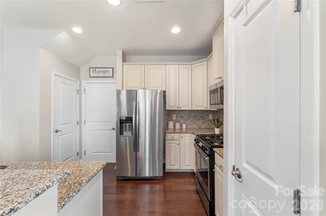 a view of a kitchen with a sink and refrigerator