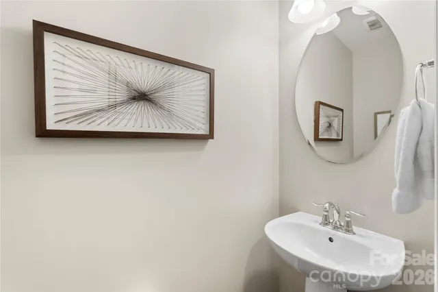 a view of bathroom with a sink and mirror