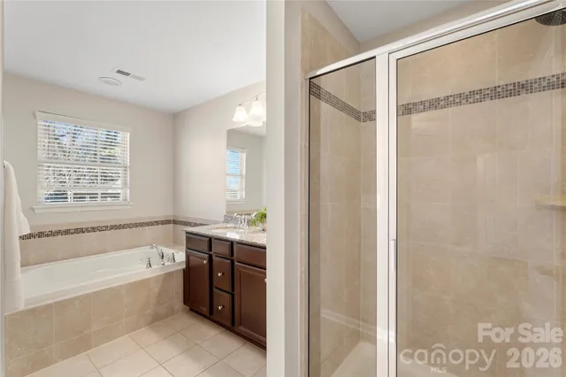 a spacious bathroom with a bathtub and a shower