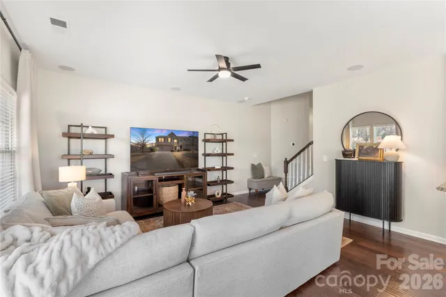 a living room with furniture a ceiling fan and a rug
