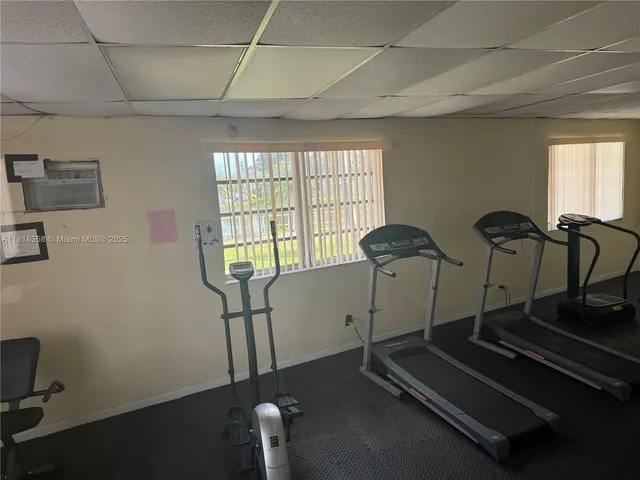 a room with gym equipment and a large window