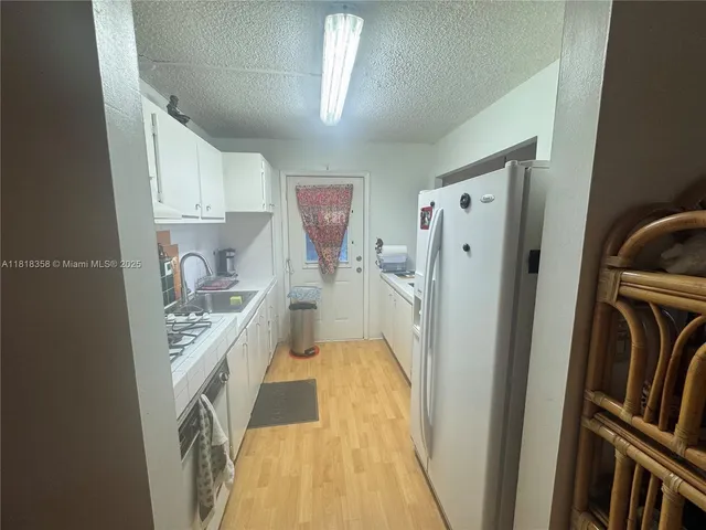 a view of a kitchen with appliances