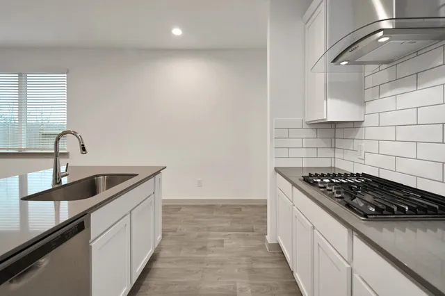 a kitchen that has a sink and a stove