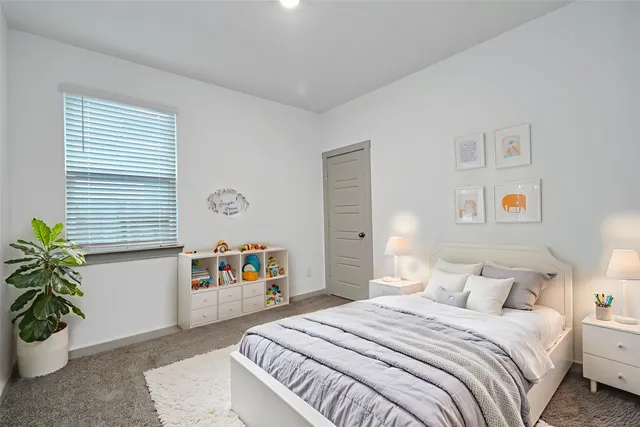 a bedroom with a bed and a large window