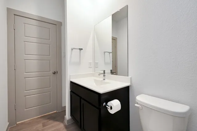 a bathroom with a sink a toilet and a mirror