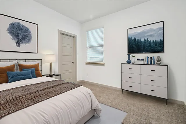 a bedroom with a bed and a dresser