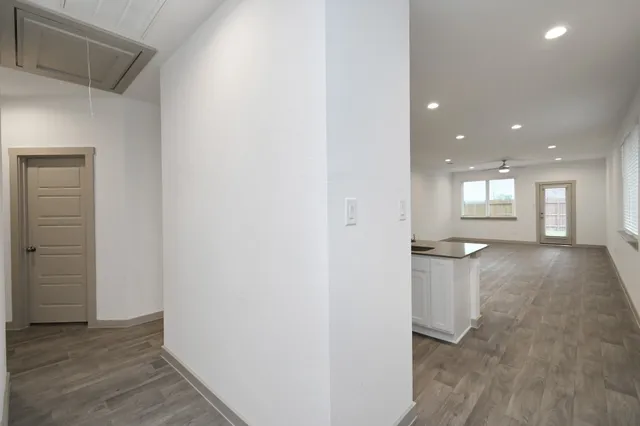 a view of empty room with wooden floor
