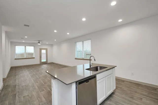 a kitchen with stainless steel appliances granite countertop a sink and a granite counter tops