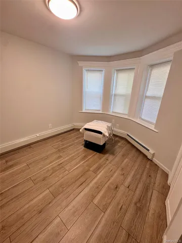 a view of a room with wooden floor and window