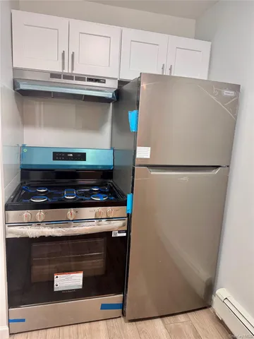 a stove top oven sitting inside of a kitchen