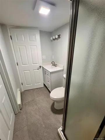 a bathroom with a sink a toilet a tub and a mirror