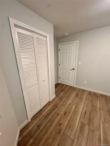 a view of a room with wooden floor and white doors