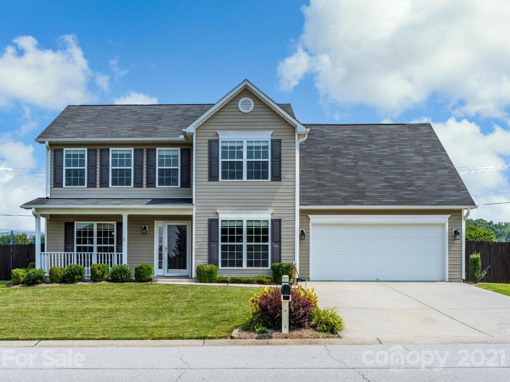 20 Roanoke Road Fletcher, NC 28732 - Photo 2 of 36 a front view of a house with a yard and garage