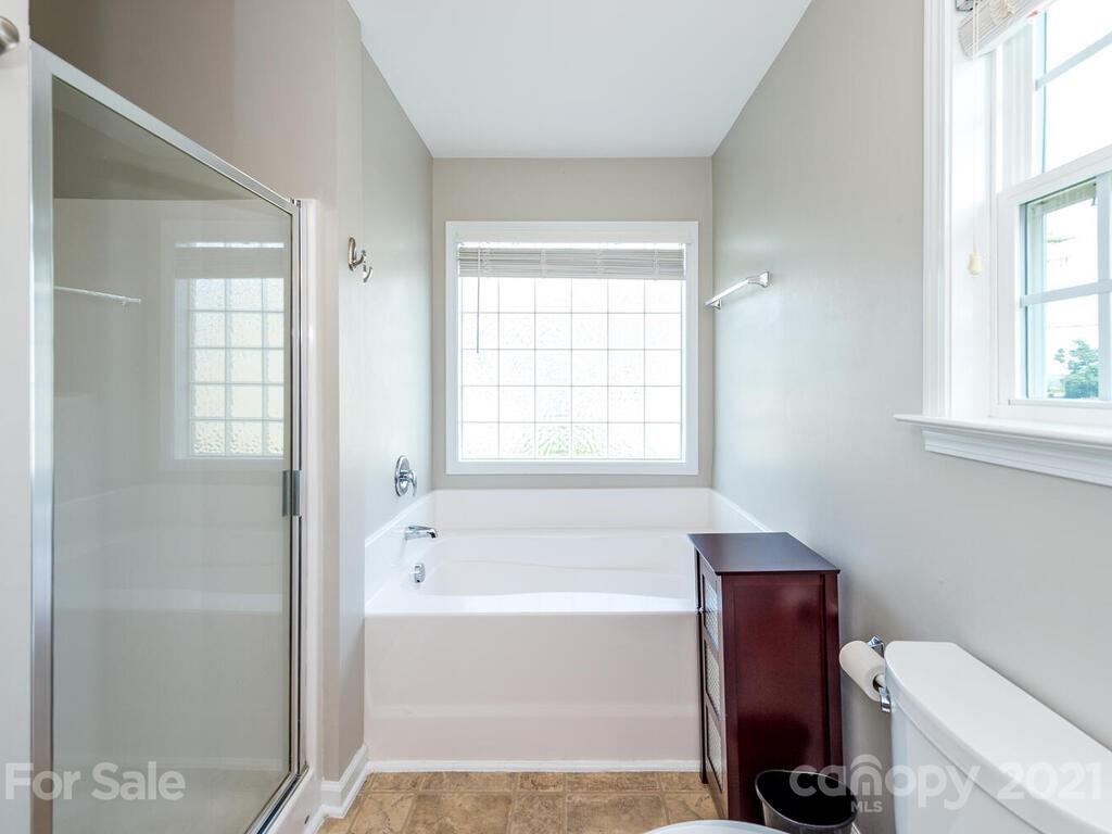 20 Roanoke Road Fletcher, NC 28732 - Photo 21 of 36 a bathroom with a bathtub shower and toilet