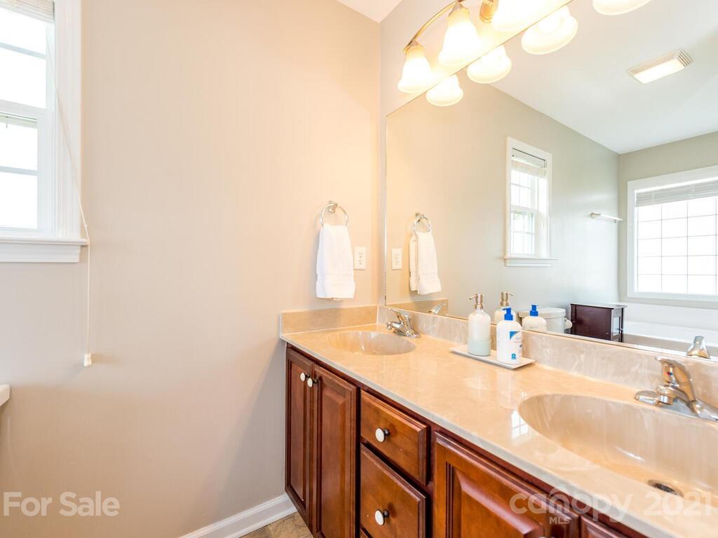 20 Roanoke Road Fletcher, NC 28732 - Photo 22 of 36 a bathroom with a sink vanity and a mirror
