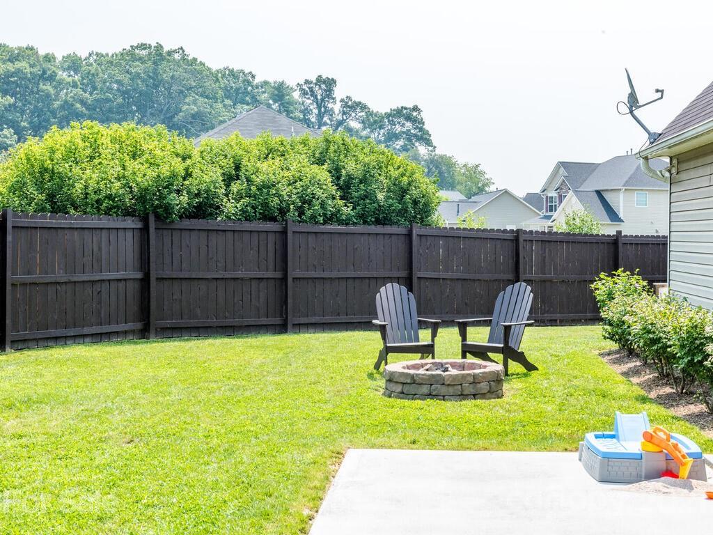 20 Roanoke Road Fletcher, NC 28732 - Photo 29 of 36 a view of a garden with a chair and potted plants