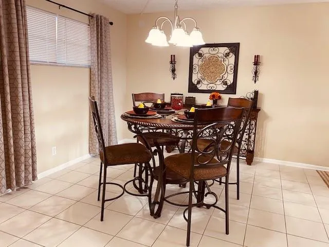 a view of a dining room with furniture and chandelier