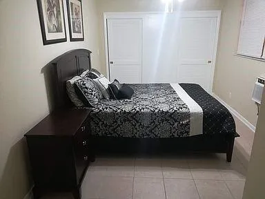 a bedroom with a bed and dresser