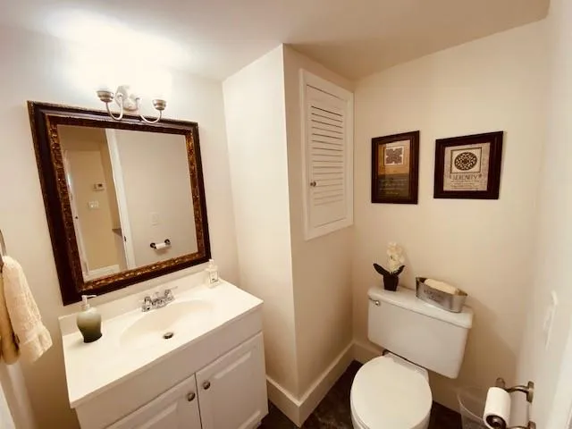 a bathroom with a toilet sink and mirror