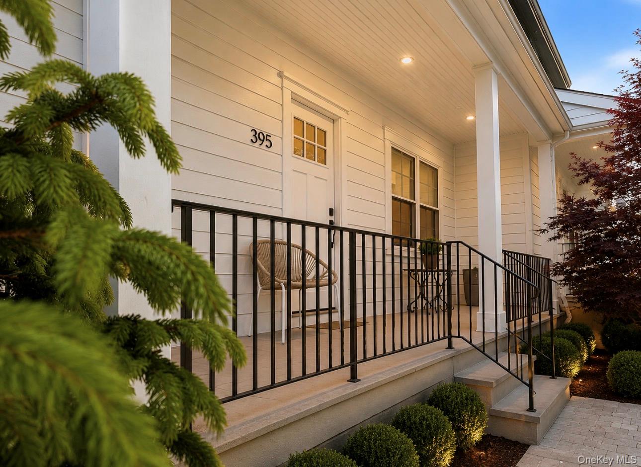 395 5th Avenue New Rochelle, NY 10801 - Photo 4 of 26 a view of a porch with a floor to ceiling window and potted plants