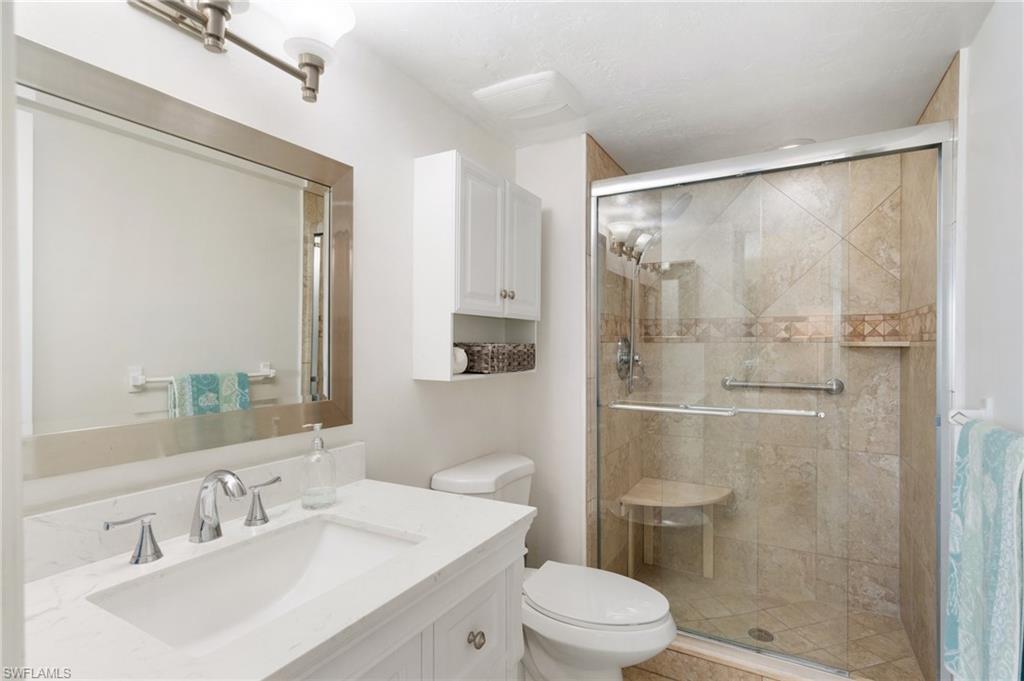305 Goodlette-Frank Road, Unit C204 Naples, FL 34102 - Photo 11 of 16 a bathroom with a sink mirror shower and toilet