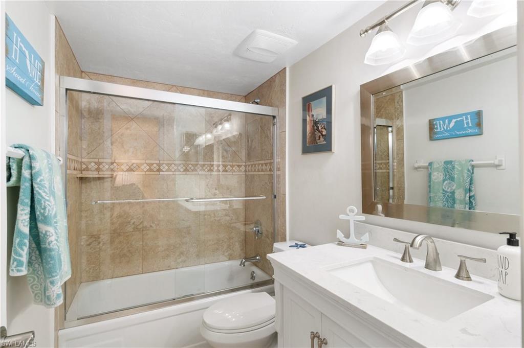 305 Goodlette-Frank Road, Unit C204 Naples, FL 34102 - Photo 12 of 16 a bathroom with a sink a toilet and shower