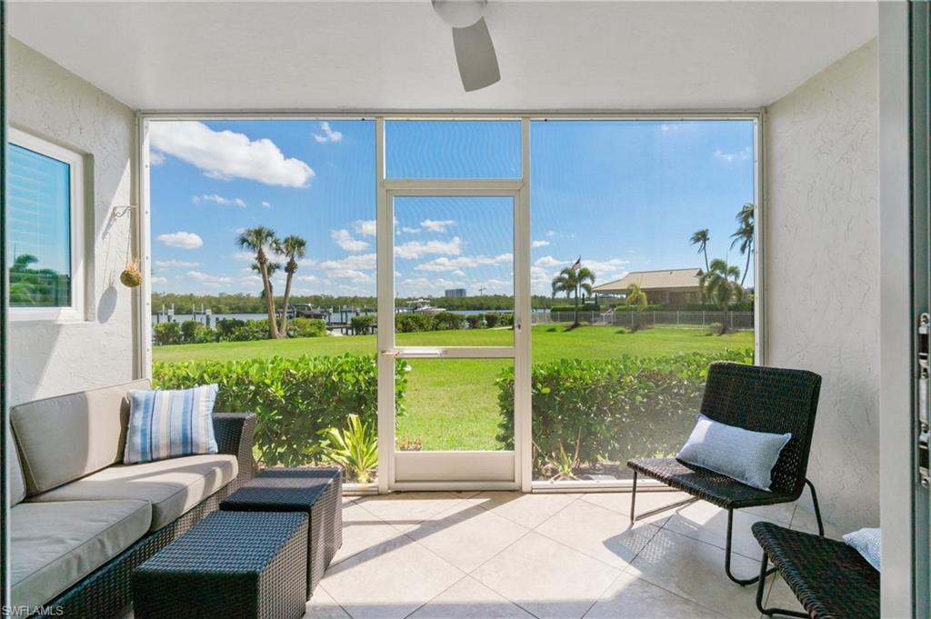 305 Goodlette-Frank Road, Unit C204 Naples, FL 34102 - Photo 14 of 16 a living room with furniture and a garden