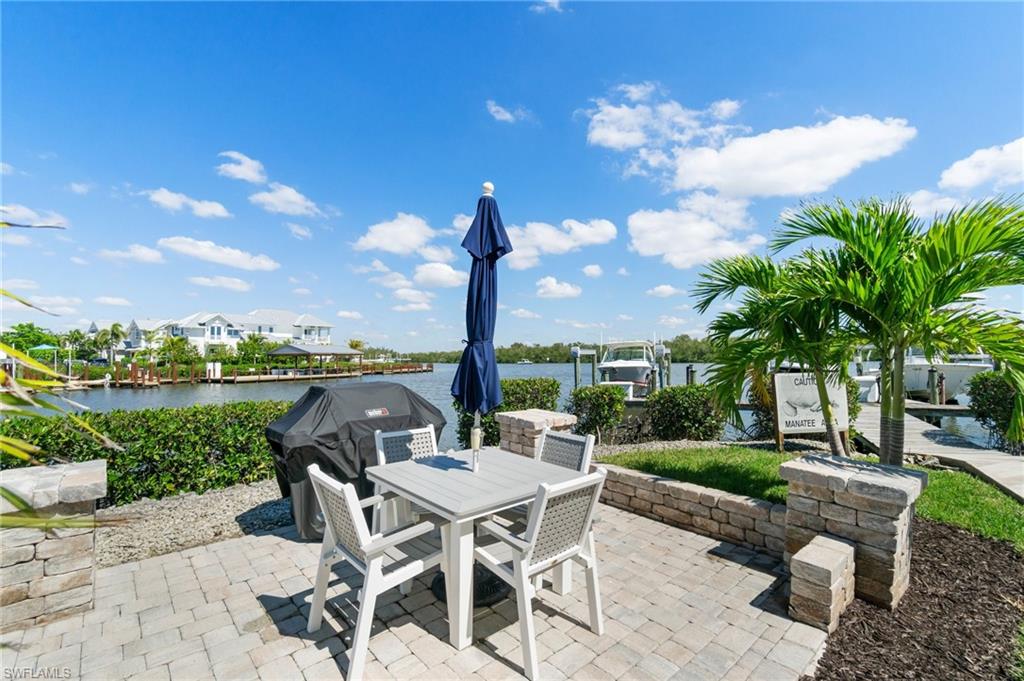 305 Goodlette-Frank Road, Unit C204 Naples, FL 34102 - Photo 3 of 16 a view of a patio with a table & chairs