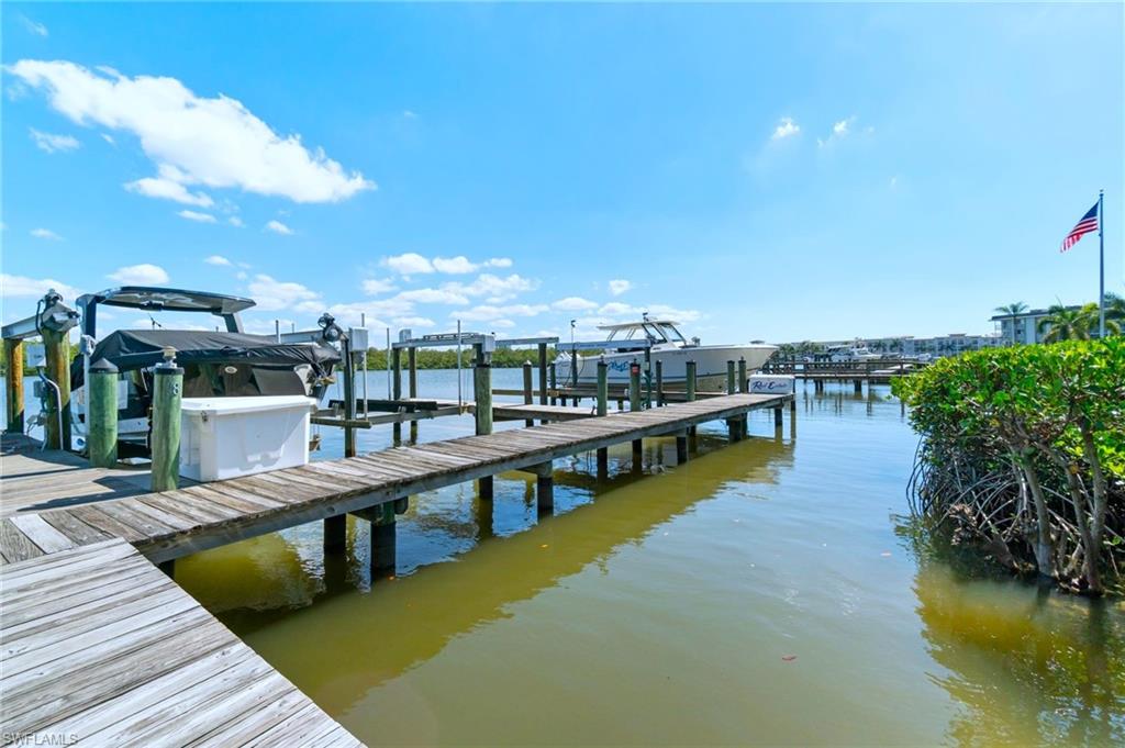 305 Goodlette-Frank Road, Unit C204 Naples, FL 34102 - Photo 5 of 16 a view of a swimming pool with seating area