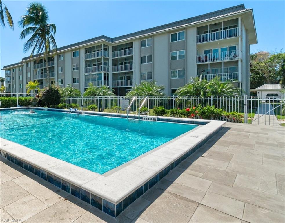 305 Goodlette-Frank Road, Unit C204 Naples, FL 34102 - Photo 6 of 16 a view of a house with a yard and potted plants