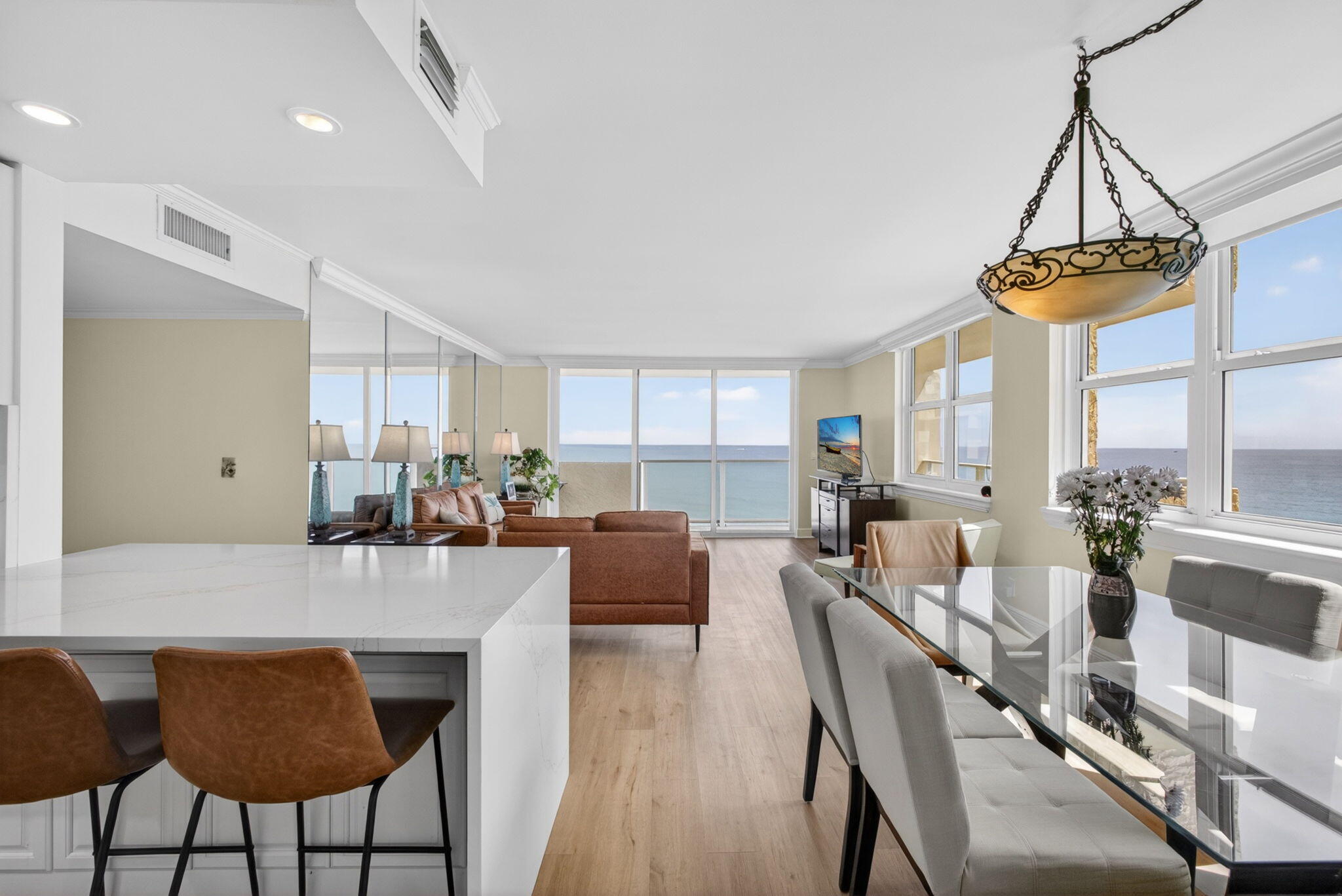 5440 North Ocean Drive, Unit 1006 Riviera Beach, FL 33404 - Photo 11 of 57 a view of a dining room and livingroom with furniture wooden floor a chandelier