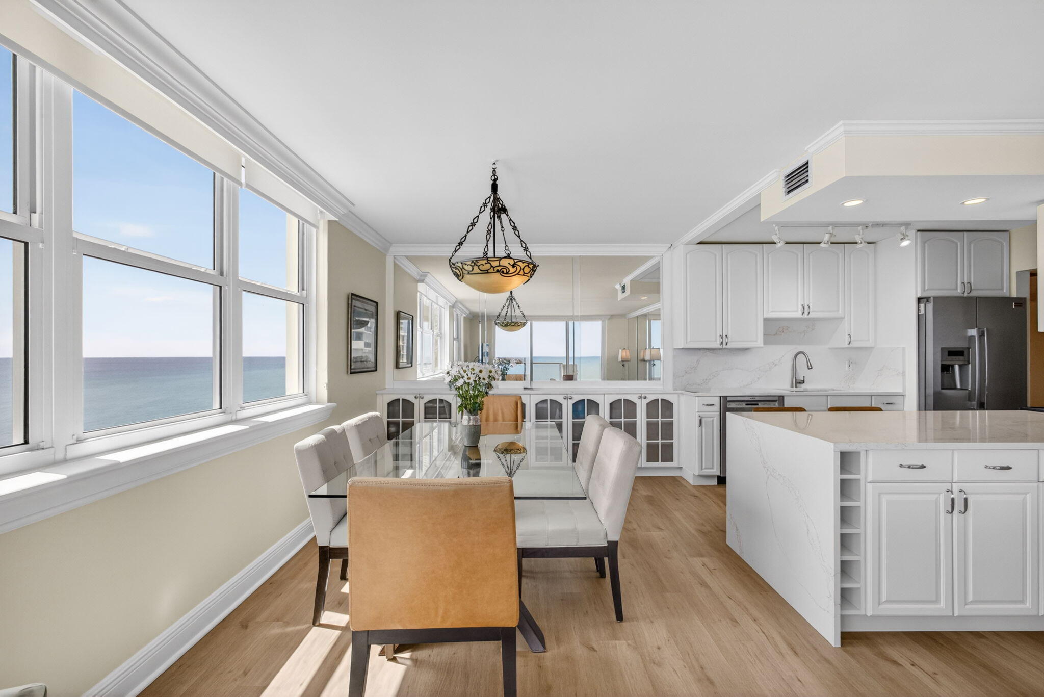 5440 North Ocean Drive, Unit 1006 Riviera Beach, FL 33404 - Photo 14 of 57 a dining room with stainless steel appliances kitchen island granite countertop a table and chairs