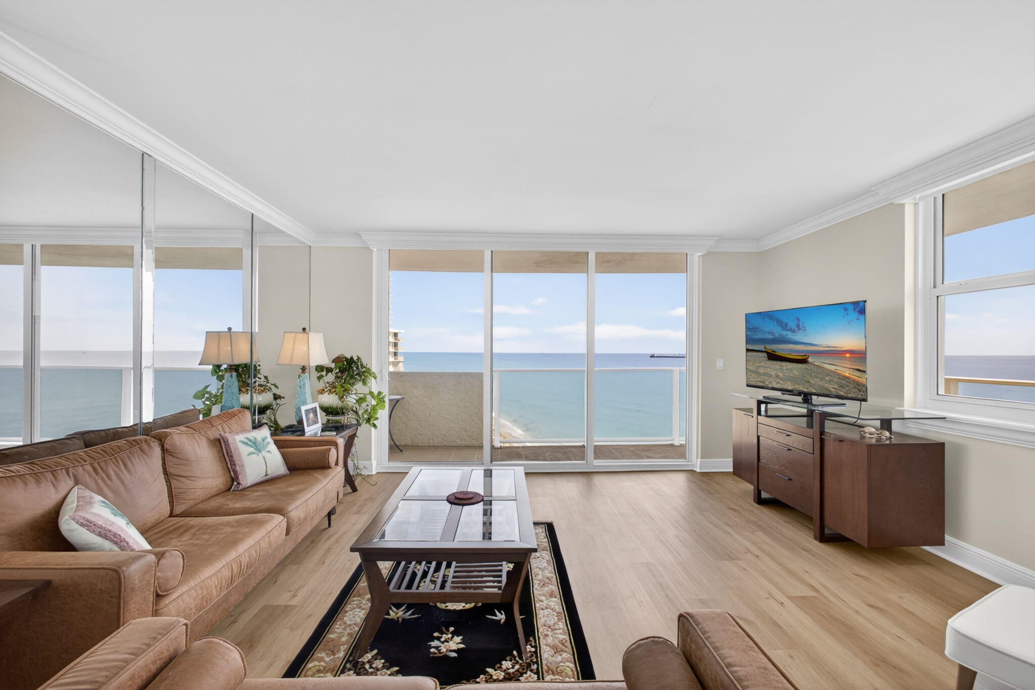 5440 North Ocean Drive, Unit 1006 Riviera Beach, FL 33404 - Photo 17 of 57 a living room with furniture large windows and flat screen tv